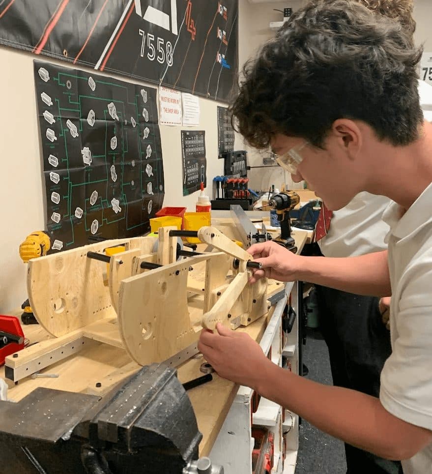 A student building the practice field out of wood